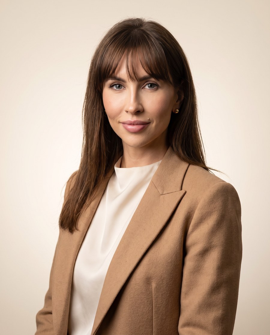 Joanna Grzesik, portret w naturalnym świetle na tle ściany w kolorze kremowym